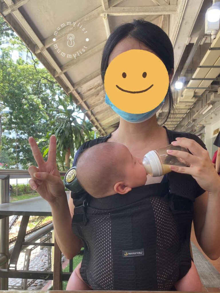 Minimonkey Baby Carrier in use while feeding baby on the go